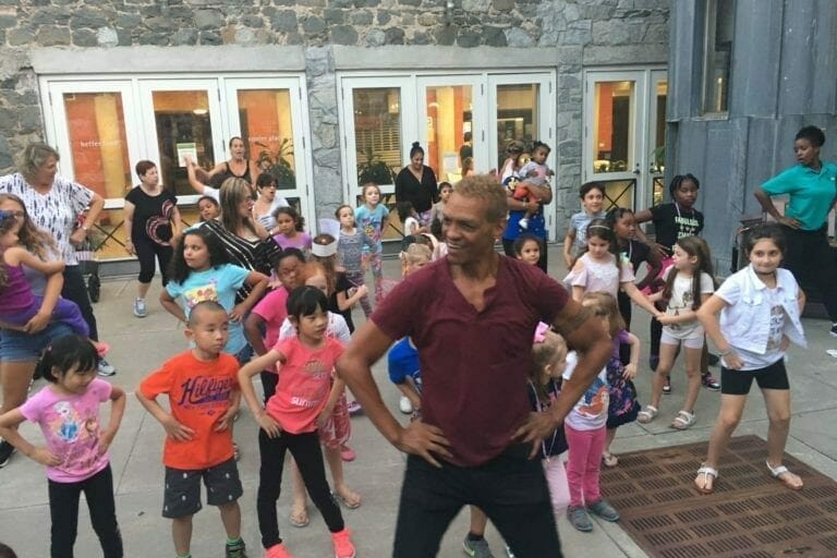 Children dancing outside during performing arts workshop.