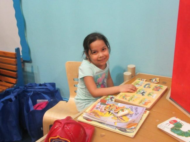 Girl-Puzzles-Rainy-Day-1024×768 child seated playing with blocks.