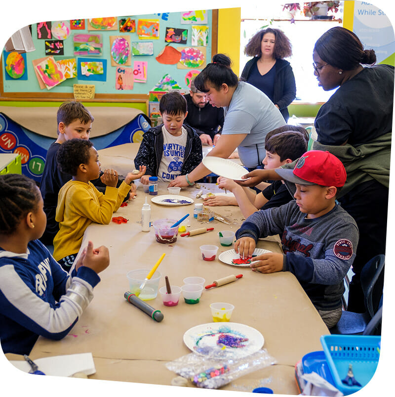 Children and adults creating arts and crafts.