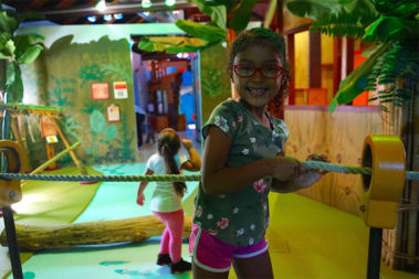 child pulling raft across river in Great Explorations exhibit