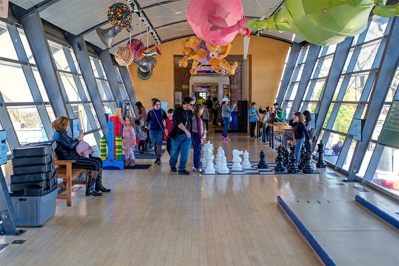 Children and parents playing in our Big Games exhibit.