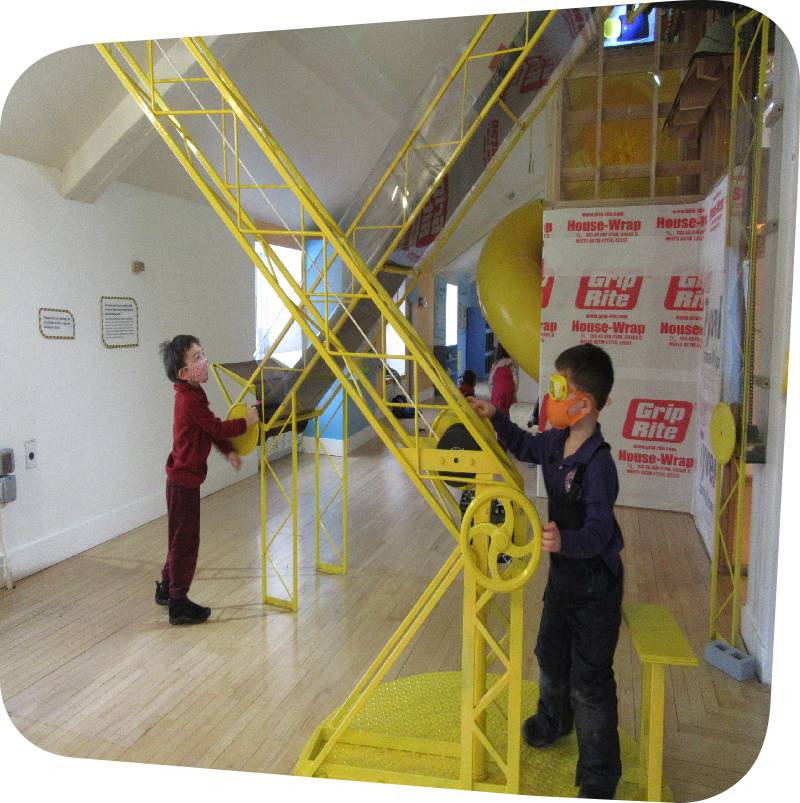 Outdoor Explorers boys with conveyer belt formatted for web children playing with conveyor belt in House About It exhibit
