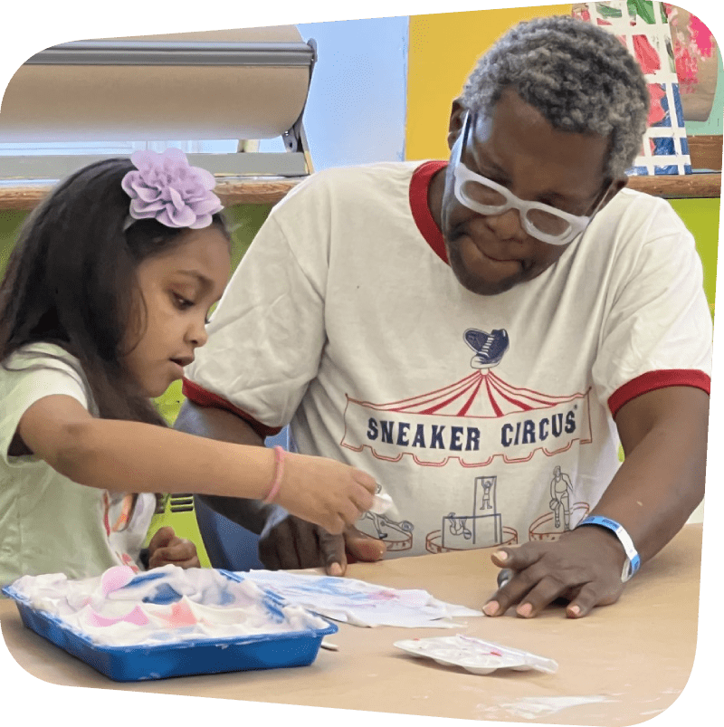 father and daughter creating marbled painting with water color infused foam