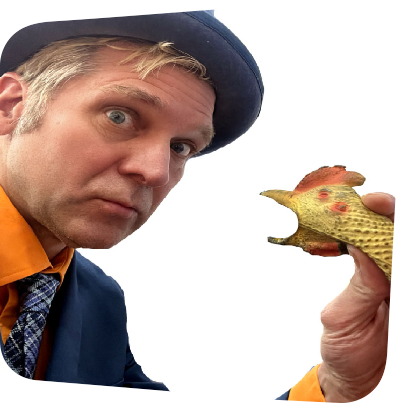 Rich the Juggler reacting to a rubber chicken with surprise and uncertainty