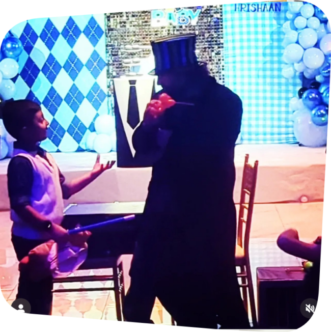 Child with mysterious magician figure on stage