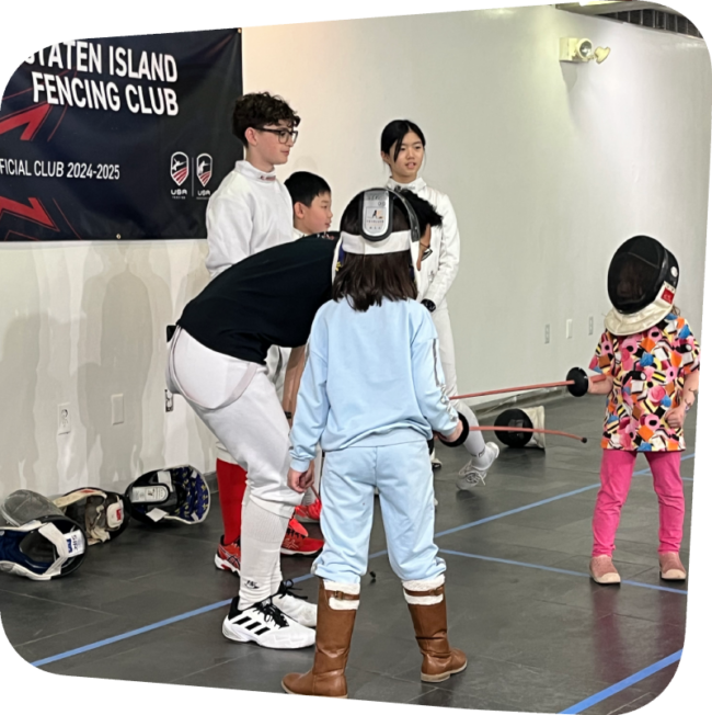 two girls learning fencing in the gallery