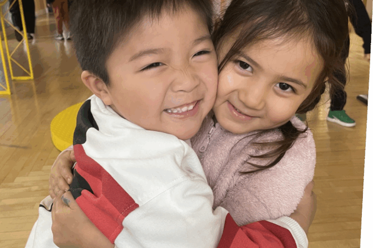 Two kids hugging in House About It