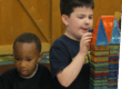 Two children building with magna-tiles in classroom