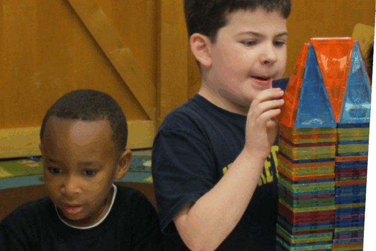 Two children building with magna-tiles in classroom