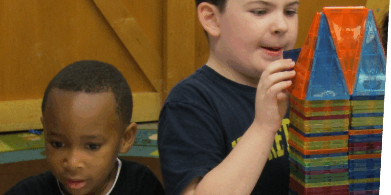Two children building with magna-tiles in classroom