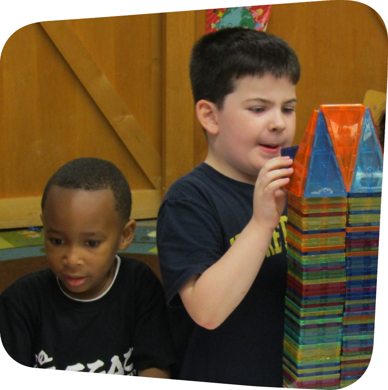 Two children building with magna-tiles in classroom