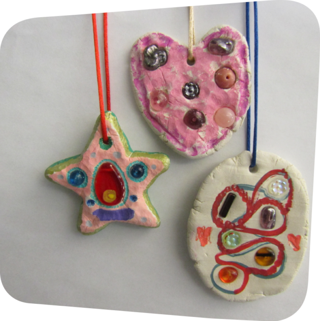 three clay art charms with gems, beads and marker on string