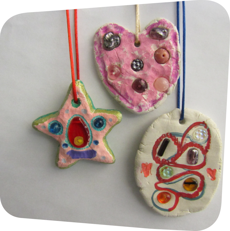 three clay art charms with gems, beads and marker on string