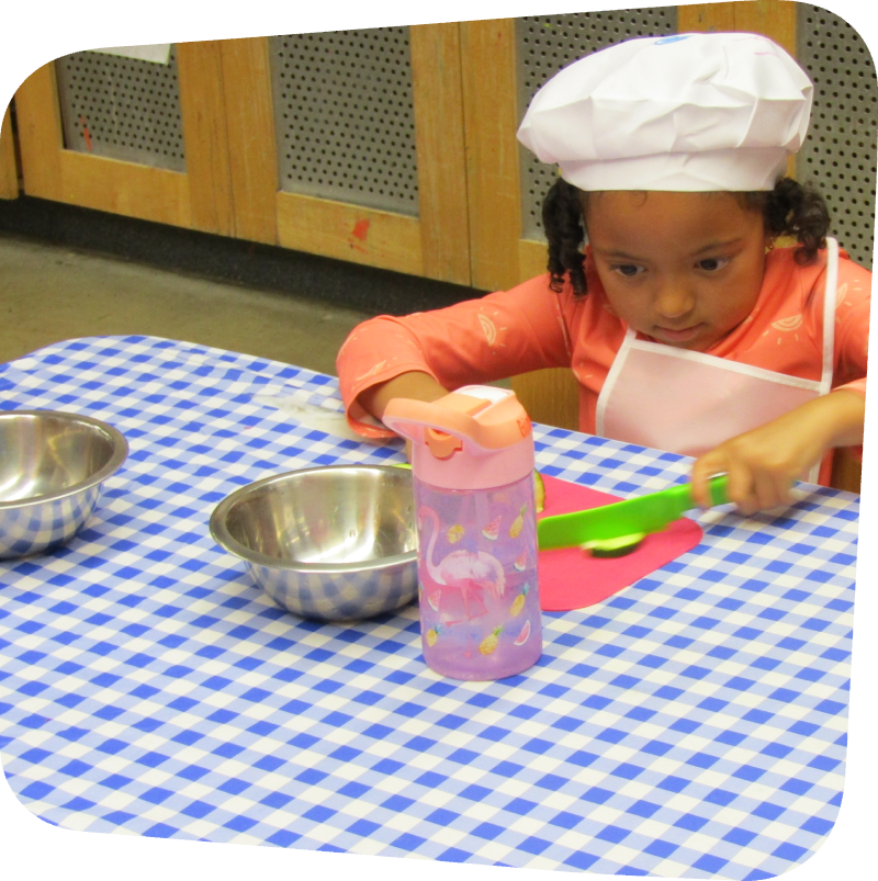 girl chopping veggies in classroom