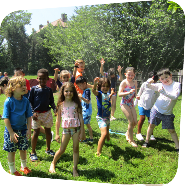 camp rhombus kids playing in sprinklers
