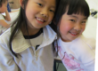 two girls smiling and hugging in the art classroom at the Staten Island Children's Museum