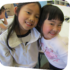 two girls smiling and hugging in the art classroom at the Staten Island Children's Museum