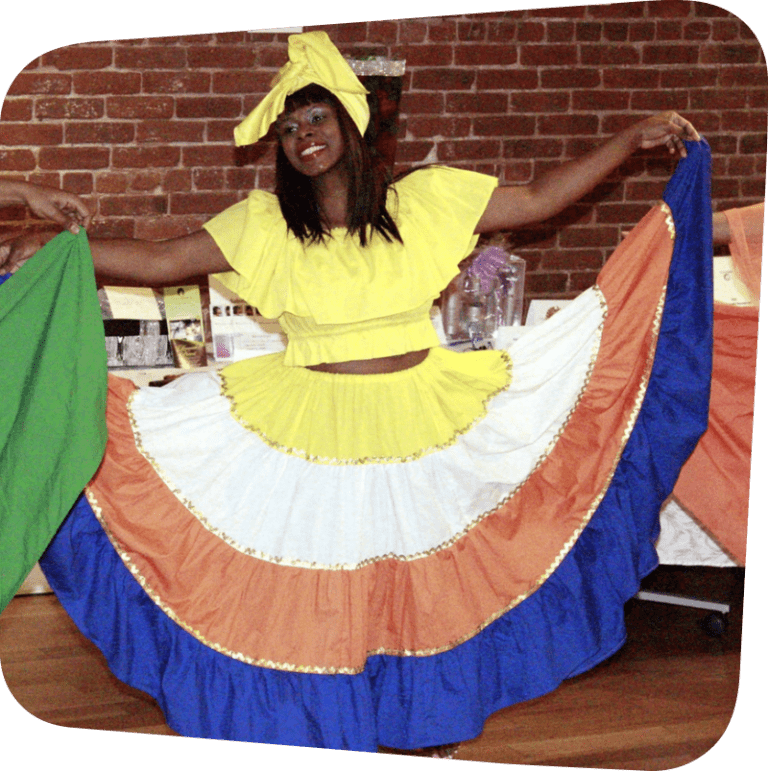 woman in traditional blue, orange and yellow haitian dance costume raising her arms costume