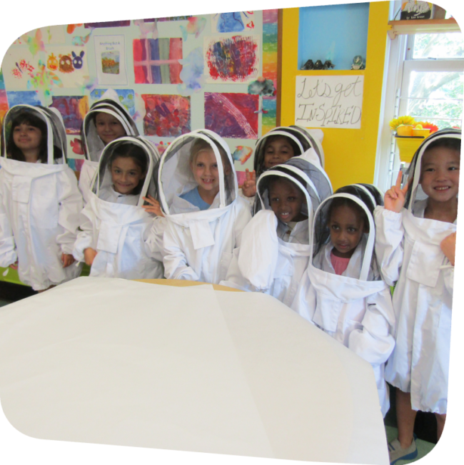 nine kids in bee suits in the classroom at the Staten Island Children's Museum