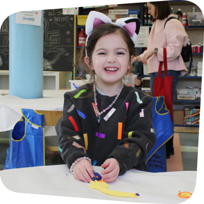 smiling girl in art class constructing art