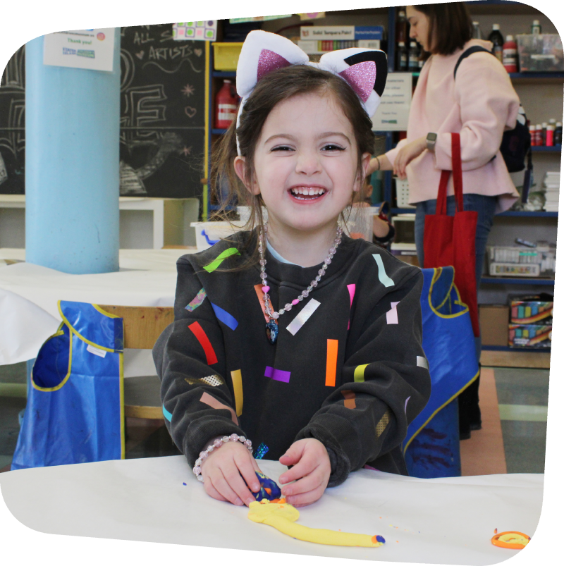 smiling girl in art class constructing art