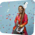 Divi Roxx Kids holding a bass guitar with confetti falling around her