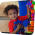smiling boy playing at the light bright in big games t the Staten Island Children's Museum