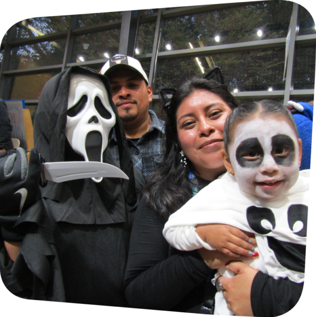 family dressed in Halloween costumes in the Big Games exhibit at The Staten Island Children's Museum