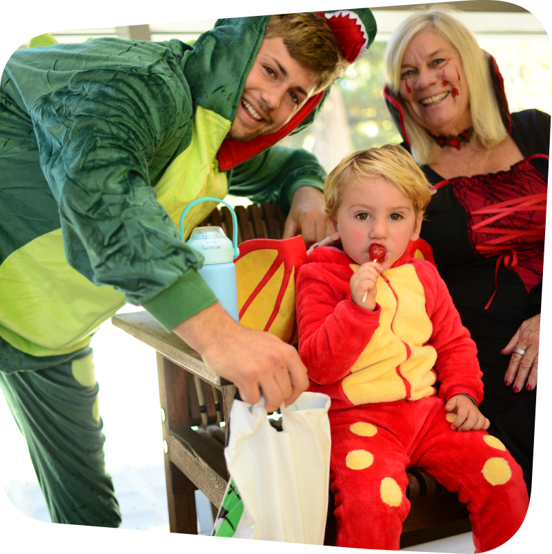 family dressed in halloween costumes with a little boy eating a lollipop at the Staten Island Children's Museum