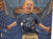 smiling boy on the rope bridge in Explore Staten Island exhibit