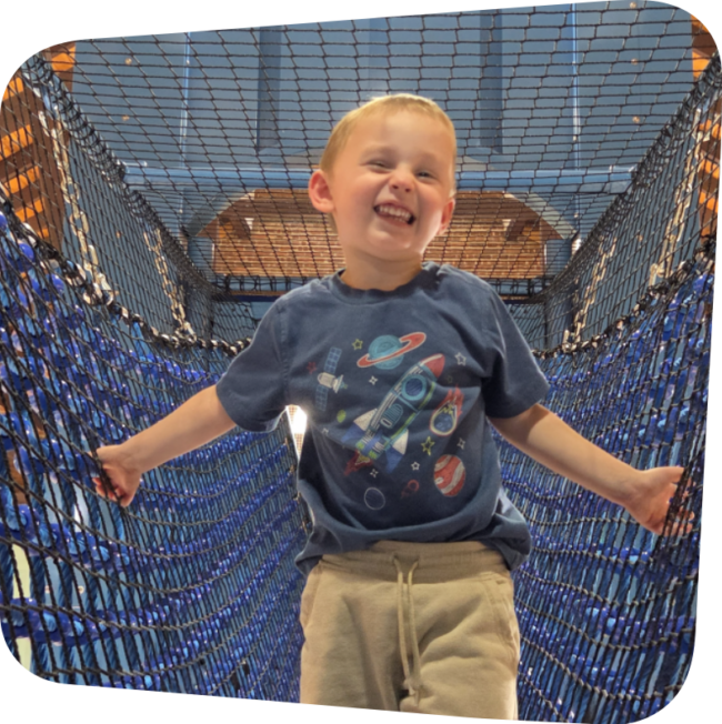 smiling boy on the rope bridge in Explore Staten Island exhibit